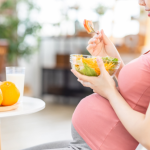 pregnant woman with food - digestion impacts your fertility