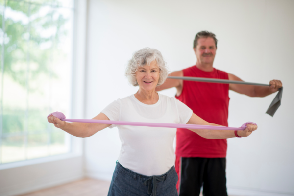 man and woman with therabands in vancouver treating pain with exercise